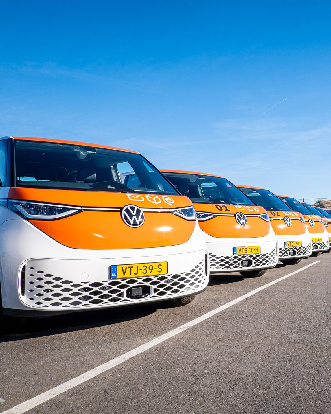 line up of PostNL vans, with signatures paint job