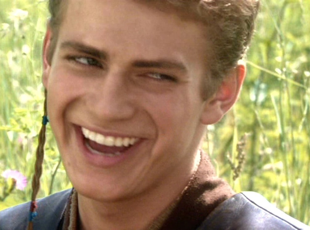 Hayden Christinsen as Anakin Skywalker in Star Wars II: Attack of the Clones, smiling at Padme Amidala.