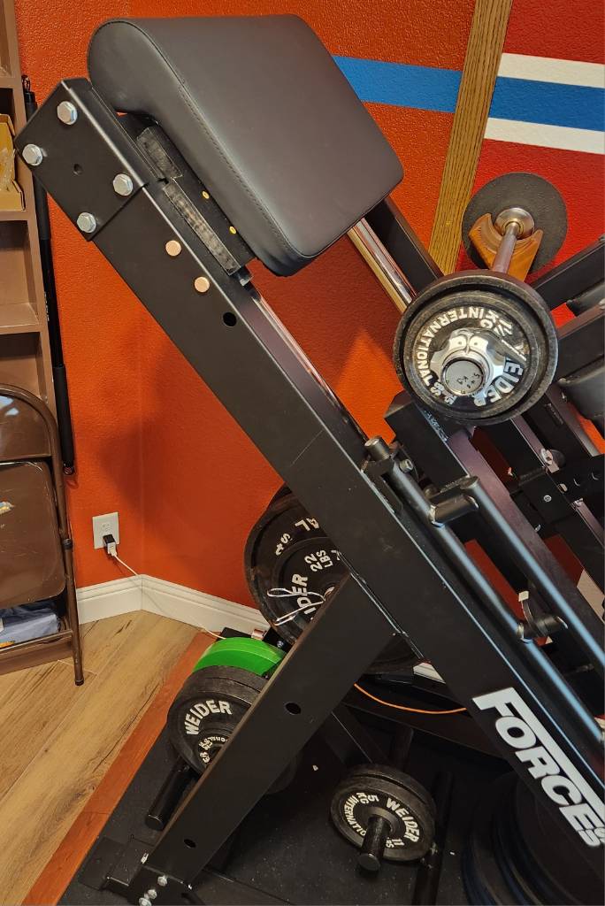 preacher curl pad attached to the top of a 45 degree leg press