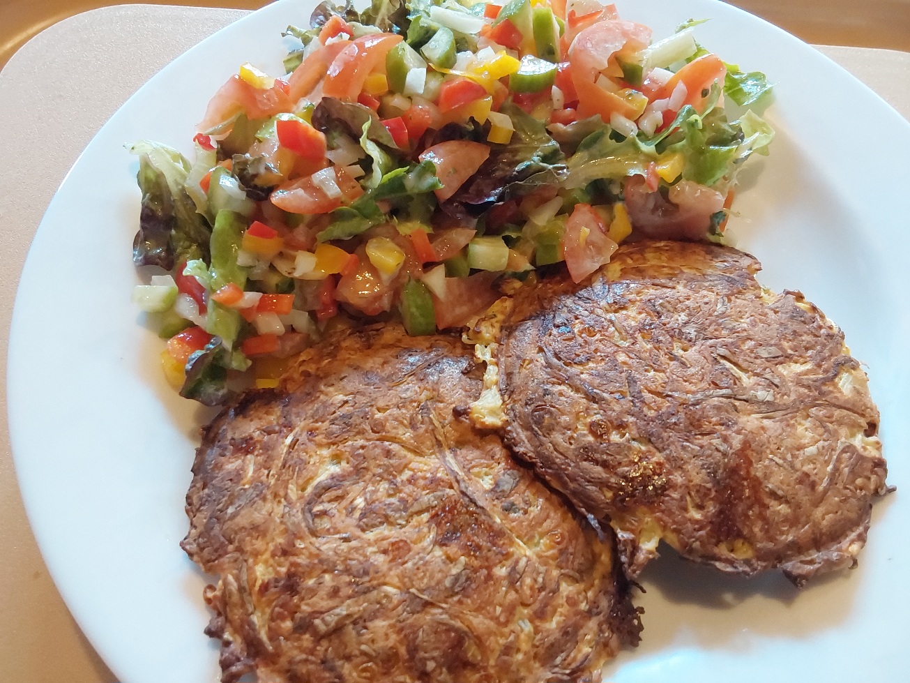 Plate of vegetable fritters served with salad