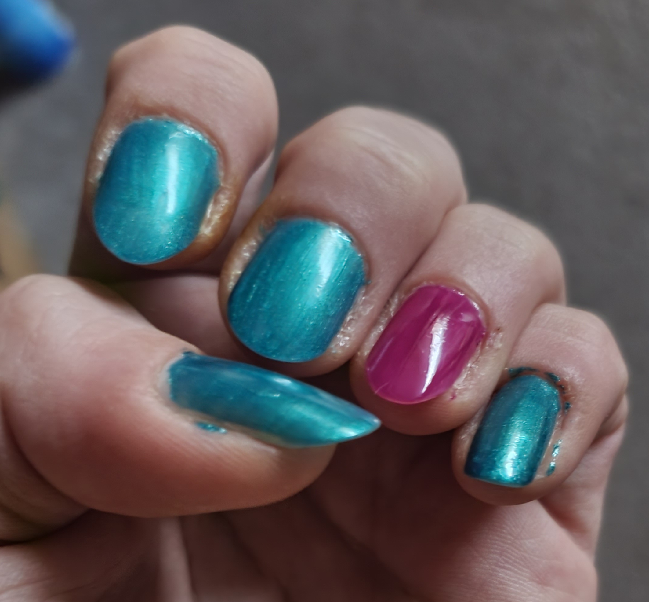 nails painted shiny blue and magenta