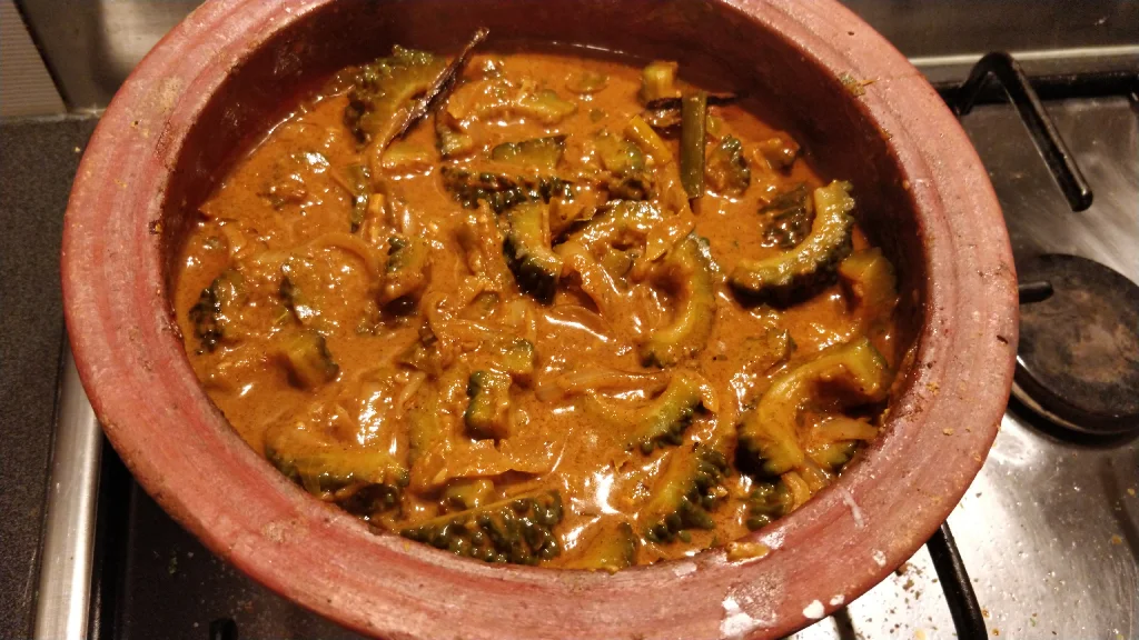 bittergourd curry in a clay pot on the stove