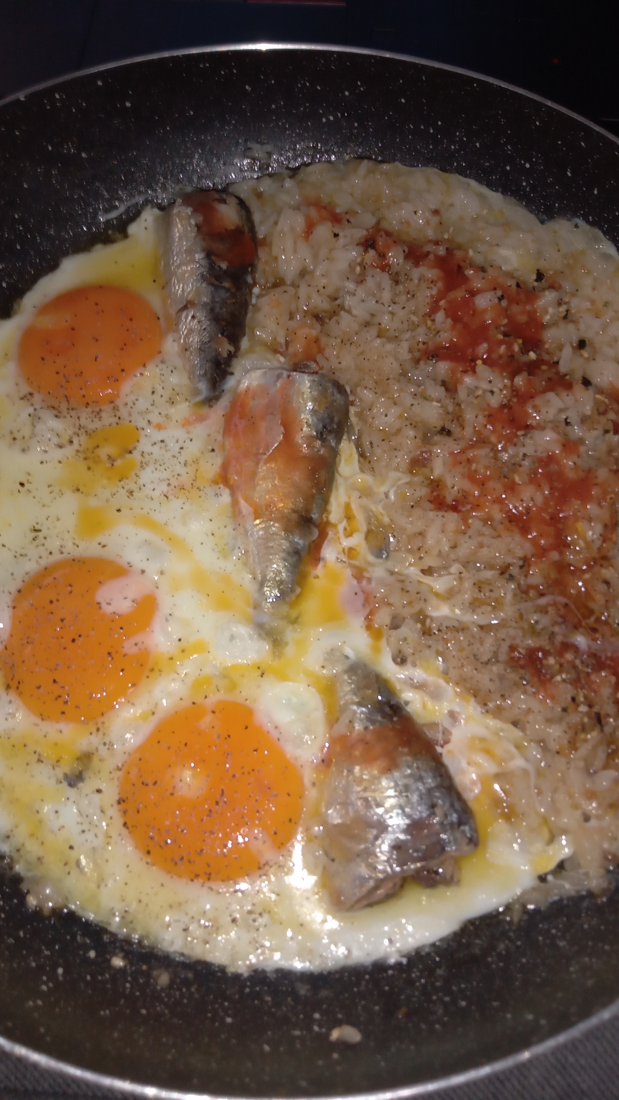 pan of eggs, sardines and rice
