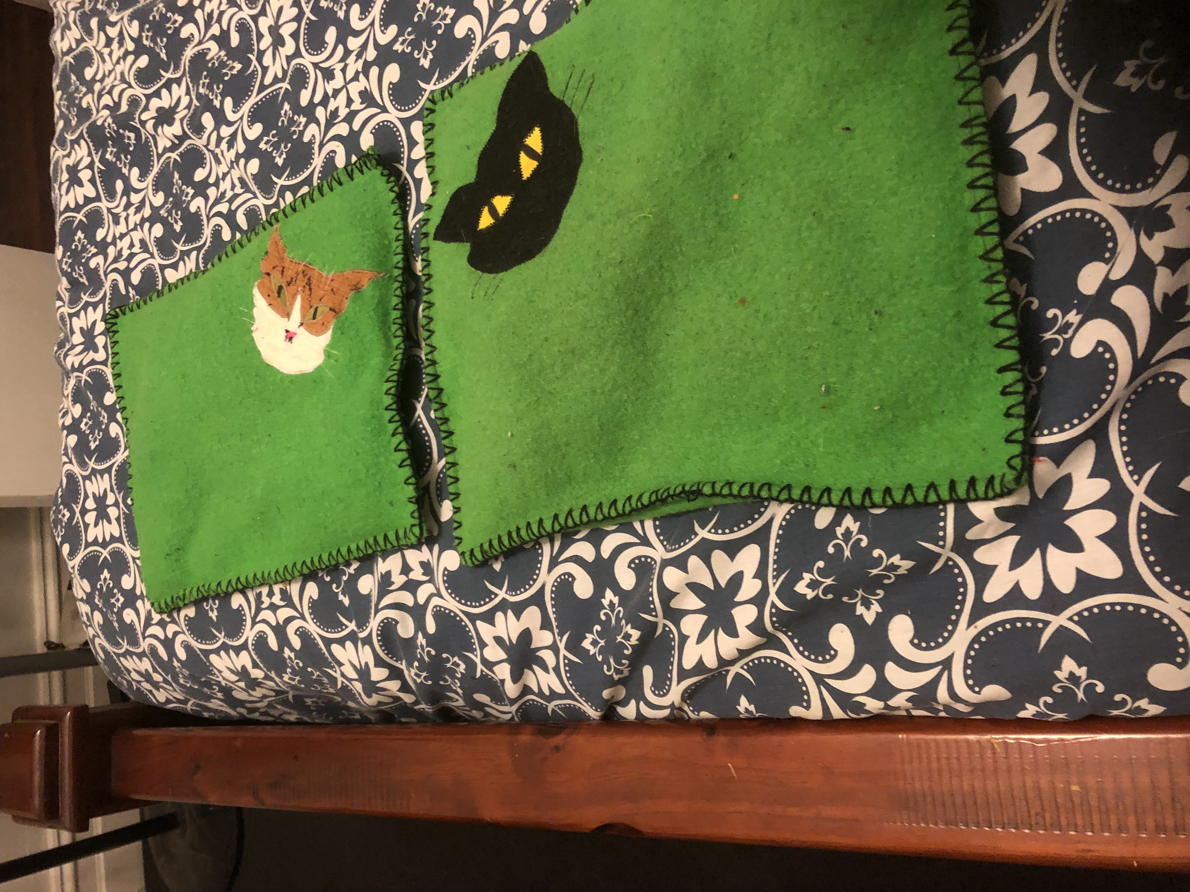 two cat appliqué cushions