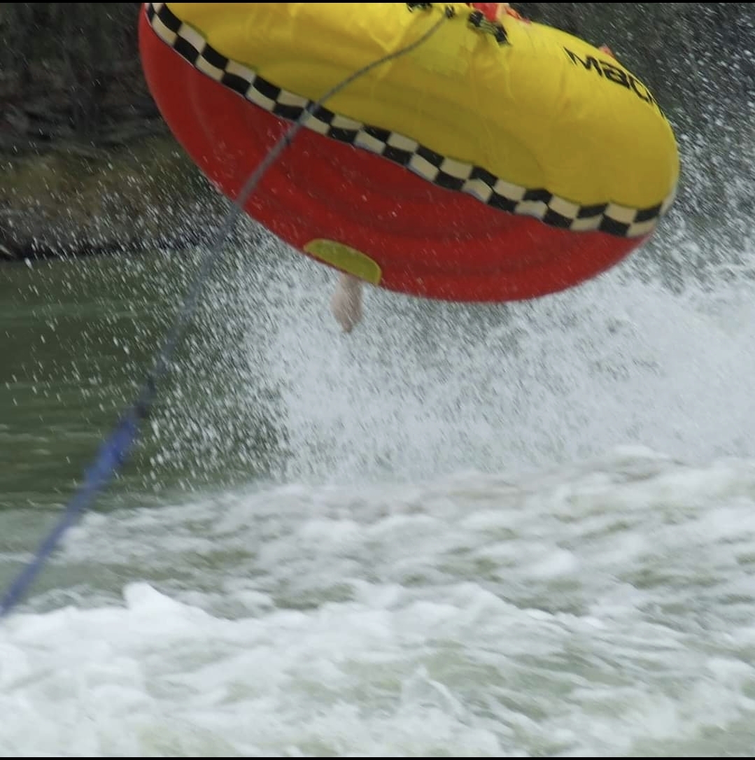 image of choppy water and the underside of a watersports inflatable biscuit