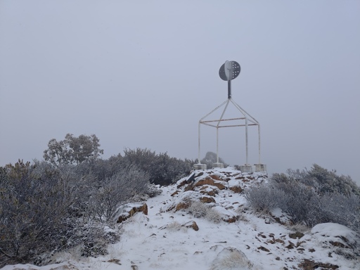 A picture of the Mt Coree trig point on a snowy day
